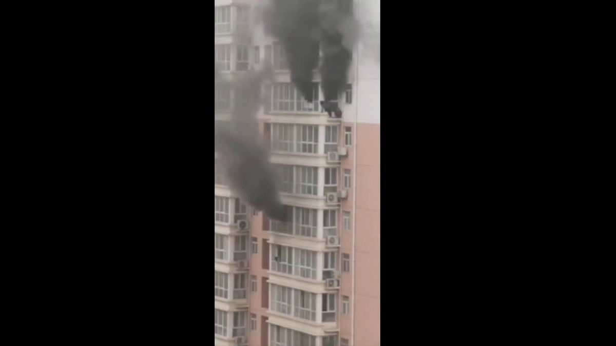 video-captures-china-residents-clinging-to-ledge-as-fire-rages-in-high-rise-apartment-building